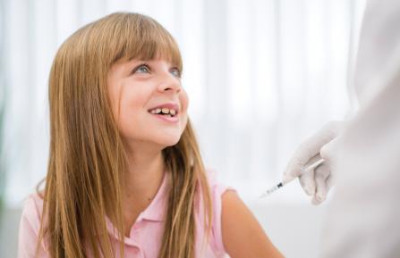 Girl receiving flu vaccination
