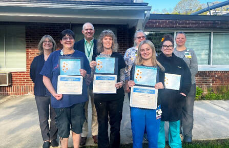 Picture of award winners with MAHHC staff members. In the photo are Sharon Laskevich, Matthew Foster, Sue DelloRusso, Moriah Tidwell, Elaine Nestor, Tammy Nourse, Gracie Rennie, Jacqueline Greenberg.
