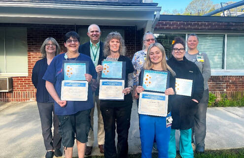Picture of award winners with MAHHC staff members. In the photo are Sharon Laskevich, Matthew Foster, Sue DelloRusso, Moriah Tidwell, Elaine Nestor, Tammy Nourse, Gracie Rennie, Jacqueline Greenberg.