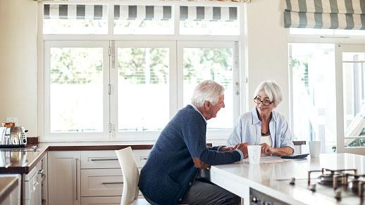 Couple talking at a kitchen counter