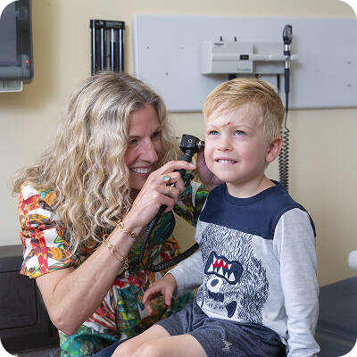 Dr. Clare Drebitko examining pediatric patient